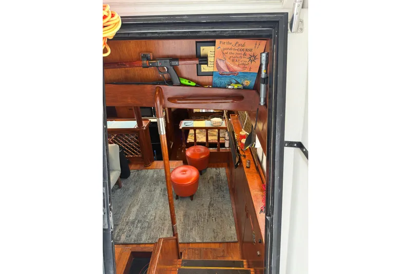 Slide: The Image of Interior view of a 1988 President 35 Double Cabin yacht, featuring wooden decor and seating. - 40