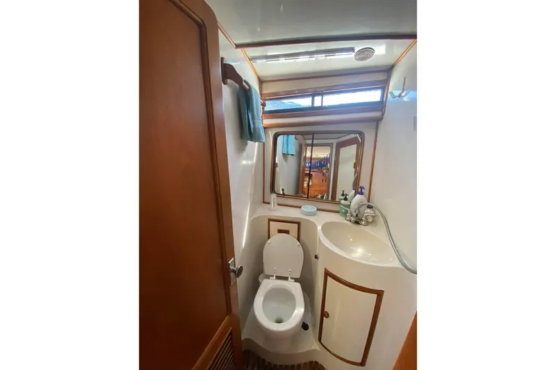 Slide: The Image of Bathroom interior of 1988 President 35 Double Cabin yacht, featuring toilet and sink. - 41