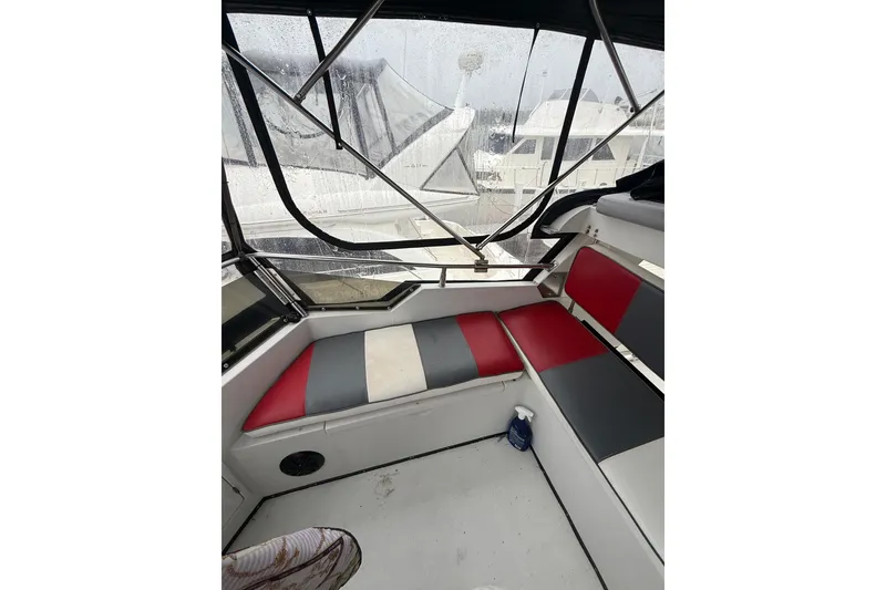 Slide: The Image of 1988 President 35 Double Cabin interior with red and gray seating, rainy window view. - 9