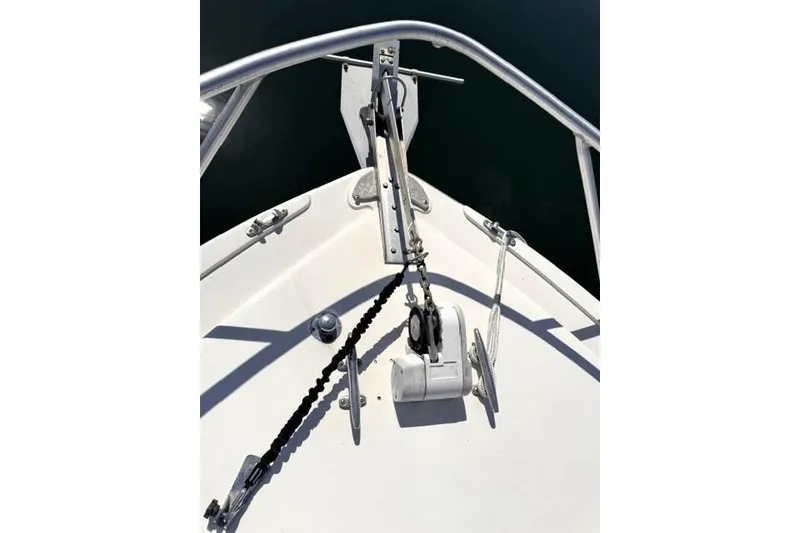 Slide: The Image of Bow of a 1991 Bertram 28 boat with anchor and railing. - 10