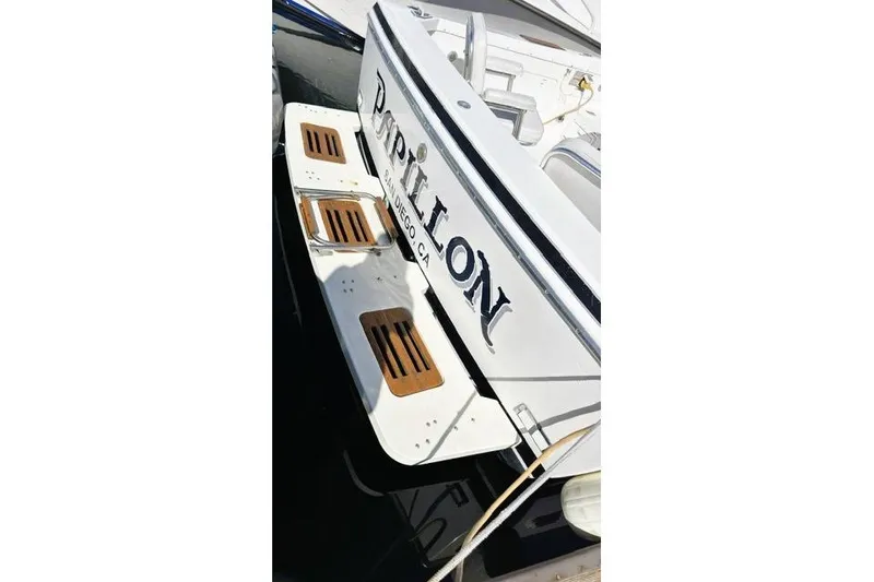 Slide: The Image of 1991 Bertram 28 boat stern with wooden steps, docked in San Diego, CA. - 11