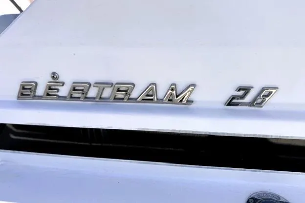 Slide: The Image of 1991 Bertram 28 boat emblem on white surface, showcasing classic design. - 12