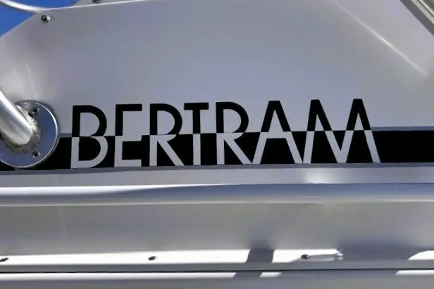 Slide: The Image of 1991 Bertram 28 boat logo on white surface, showcasing brand name in bold letters. - 13