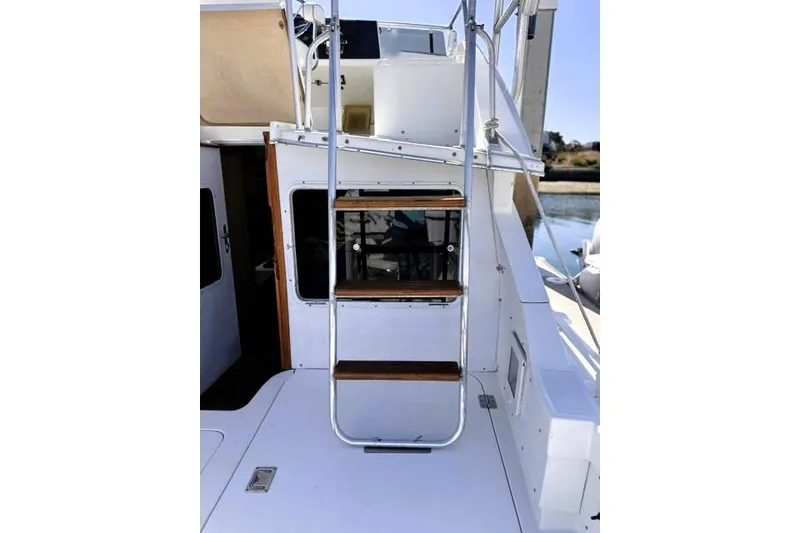 Slide: The Image of Staircase on a 1991 Bertram 28 boat, leading to the upper deck. - 17