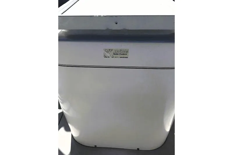 Slide: The Image of 1991 Bertram 28 boat detail with visible label and sleek white surface. - 20