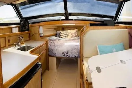 Slide: The Image of Interior of a 1991 Bertram 28 boat with cozy cabin and kitchenette. - 24