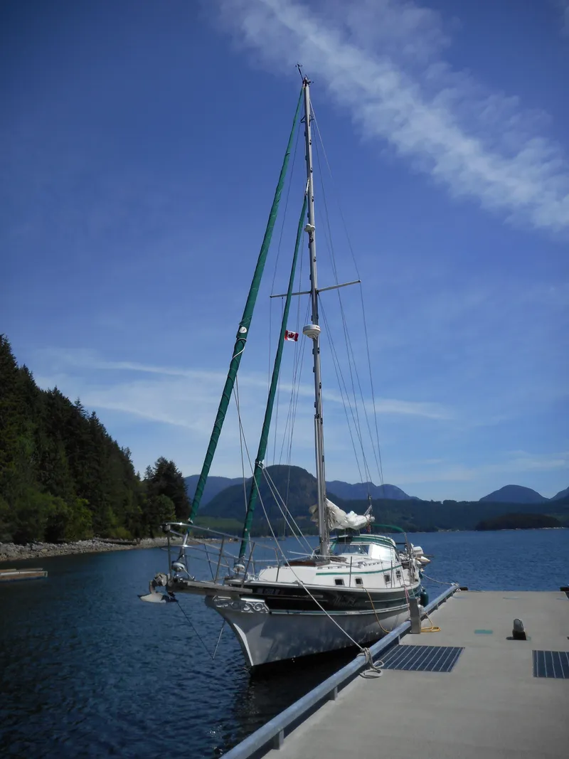 The Image of 1986 Gozzard 36 sailboat docked with mountain backdrop. - 0