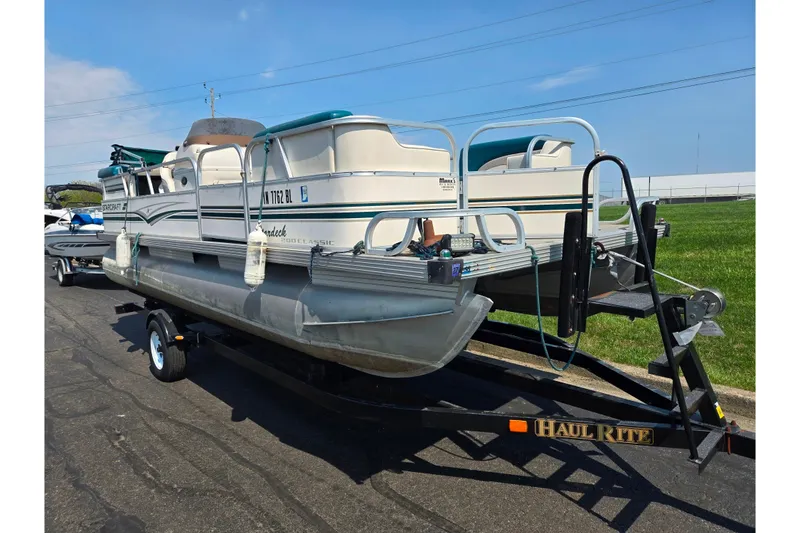 Slide: The Image of 1998 Starcraft pontoon boat on Haul Rite trailer, parked on asphalt. - 5
