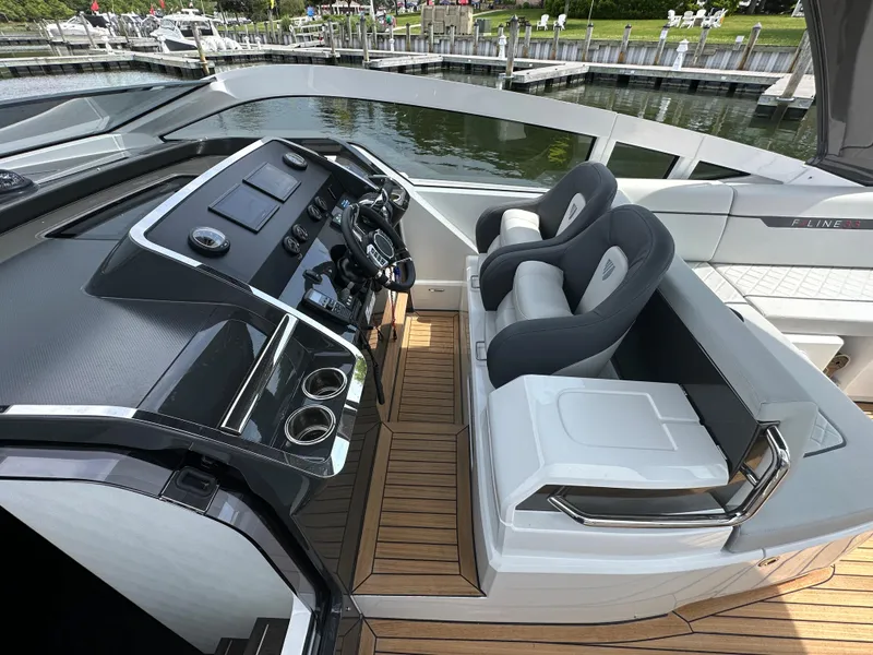 Slide: The Image of 2023 Fairline F//Line 33 Outboard cockpit with modern dashboard and comfortable seating. - 11