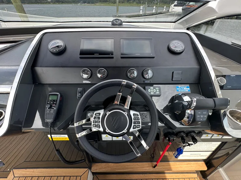 Slide: The Image of 2023 Fairline F//Line 33 Outboard helm with modern controls and navigation equipment. - 13