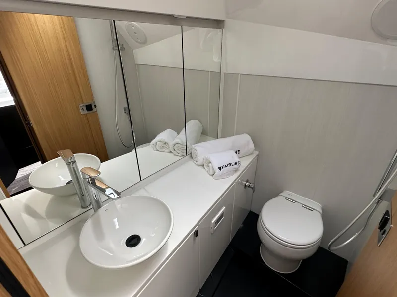 Slide: The Image of Modern bathroom in 2023 Fairline F//Line 33 Outboard yacht with sink, toilet, and mirror. - 14