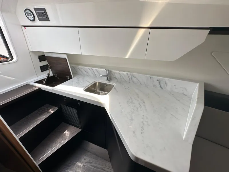 Slide: The Image of 2023 Fairline F//Line 33 Outboard yacht interior kitchen with marble countertop and sink. - 16