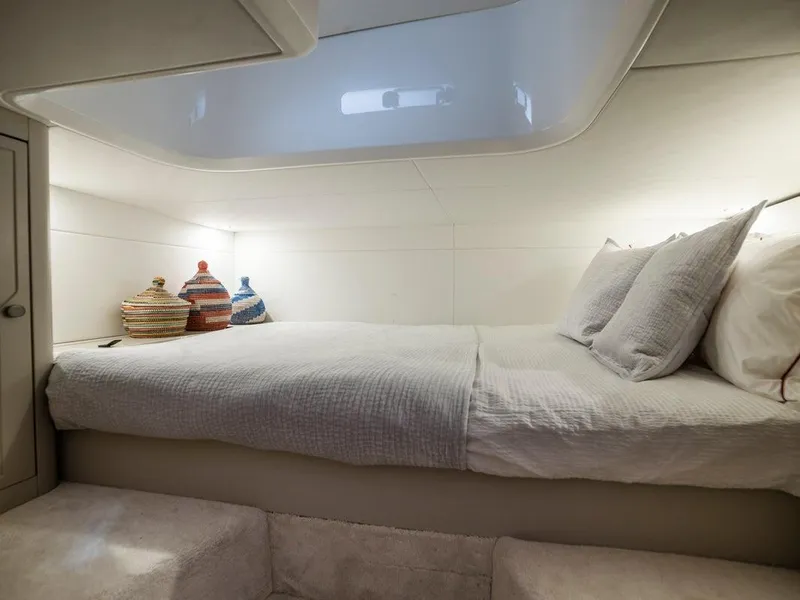 Slide: The Image of Interior cabin of 2023 Fairline F//Line 33 Outboard with cozy bed and decorative baskets. - 18