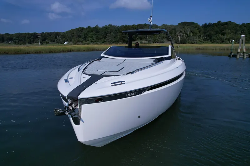 Slide: The Image of 2023 Fairline F//Line 33 Outboard luxury motor yacht on calm water. - 2