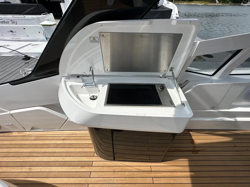 Slide: The Image of Fairline F//Line 33 Outboard 2023 yacht with open outdoor kitchenette on teak deck. - 9