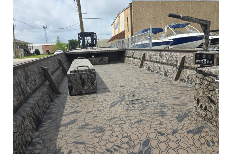 Slide: The Image of 2026 Pro-Drive 2060 boat interior with camouflage pattern, docked near other boats. - 11