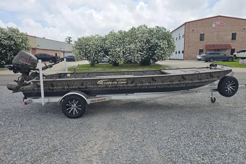 Slide: The Image of Pro-Drive 2060 boat on trailer, 2026 model, parked outdoors with buildings in background. - 3