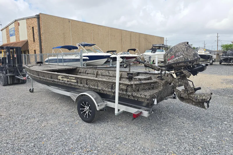 Slide: The Image of 2026 Pro-Drive 2060 boat with camouflage design on a trailer in a dealership lot. - 6