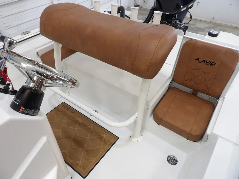Slide: The Image of Interior of Avid 207 Recon boat, 2026 model, featuring brown leather seats. - 19