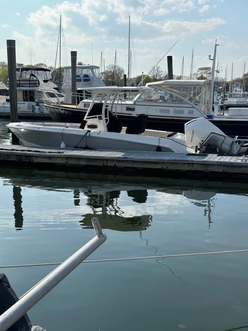 Slide: The Image of 2024 Boston Whaler 230 Outrage boat docked at marina. - 1