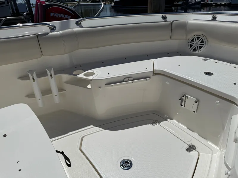Slide: The Image of Interior of 2024 Boston Whaler 230 Outrage boat, white upholstery and storage. - 14