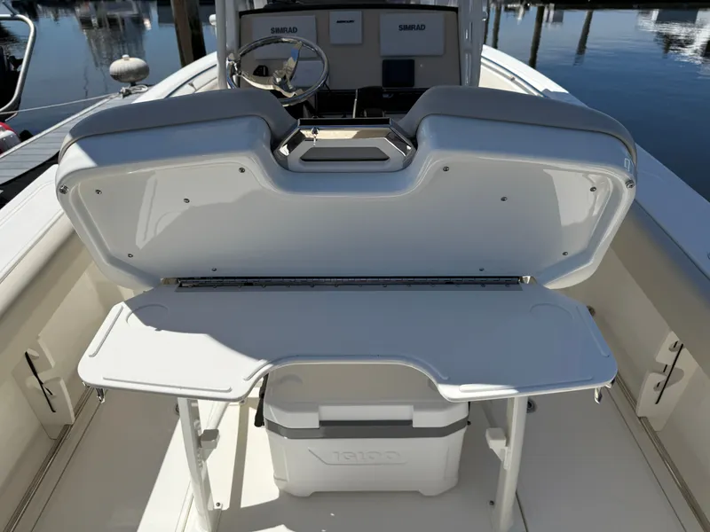 Slide: The Image of 2024 Boston Whaler 230 Outrage with foldable seat and storage area. - 29