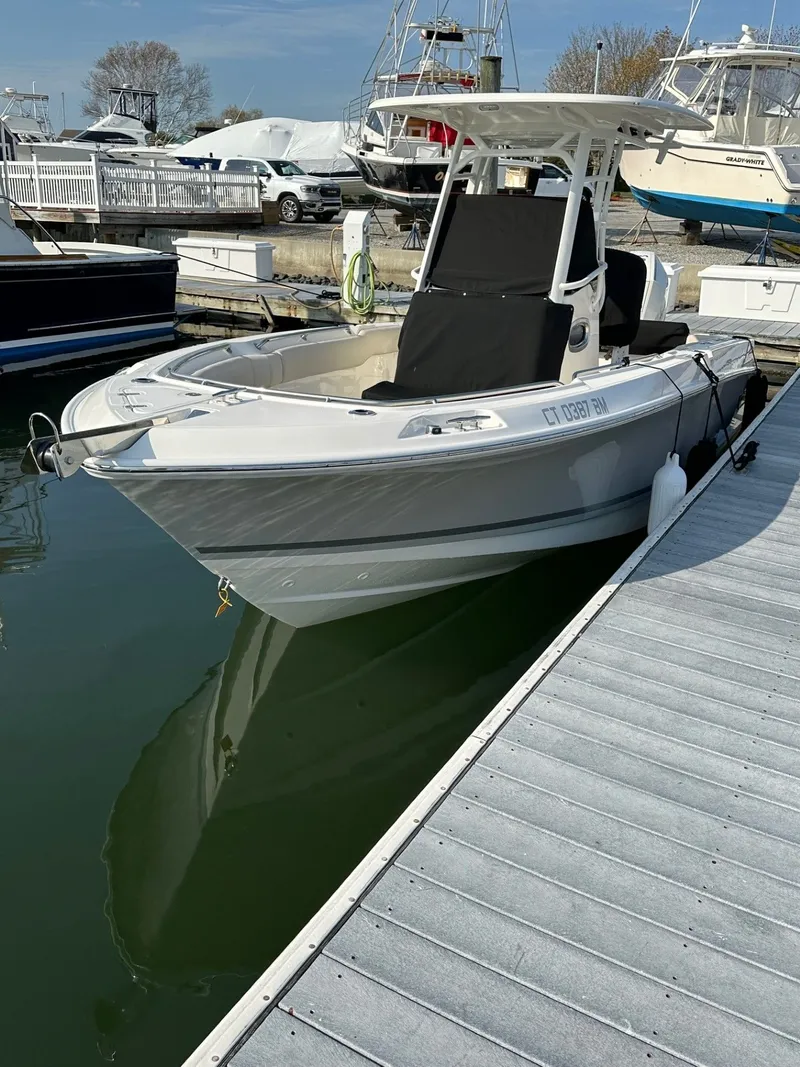 Slide: The Image of 2024 Boston Whaler 230 Outrage docked at marina. - 3