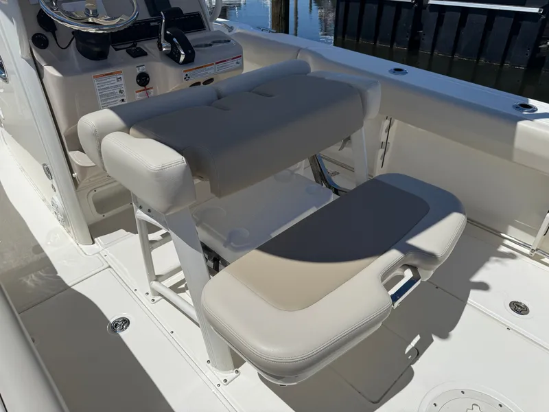 Slide: The Image of Interior of 2024 Boston Whaler 230 Outrage with bench seat and helm console. - 31