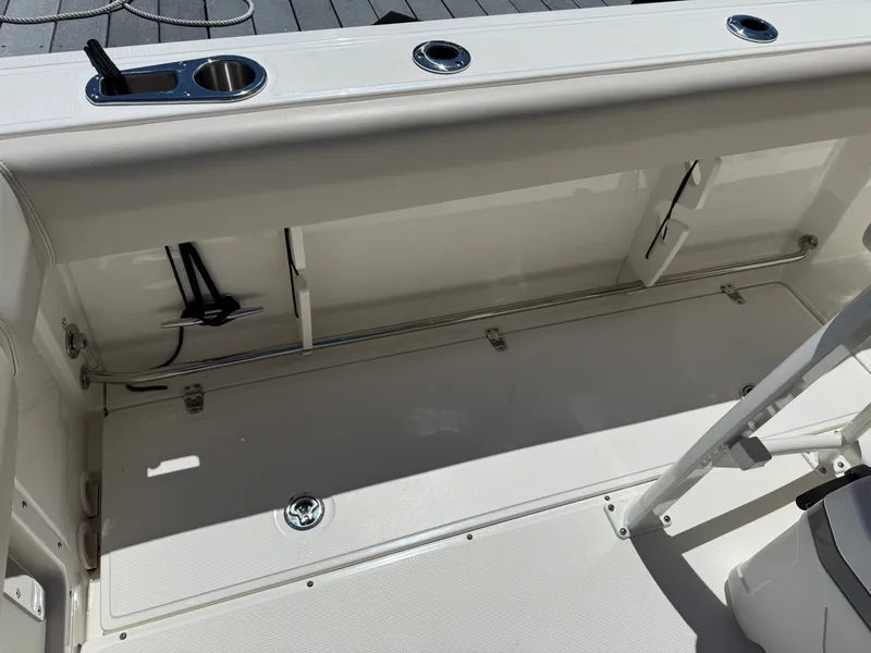 Slide: The Image of Interior of 2024 Boston Whaler 230 Outrage with storage and cup holders. - 34