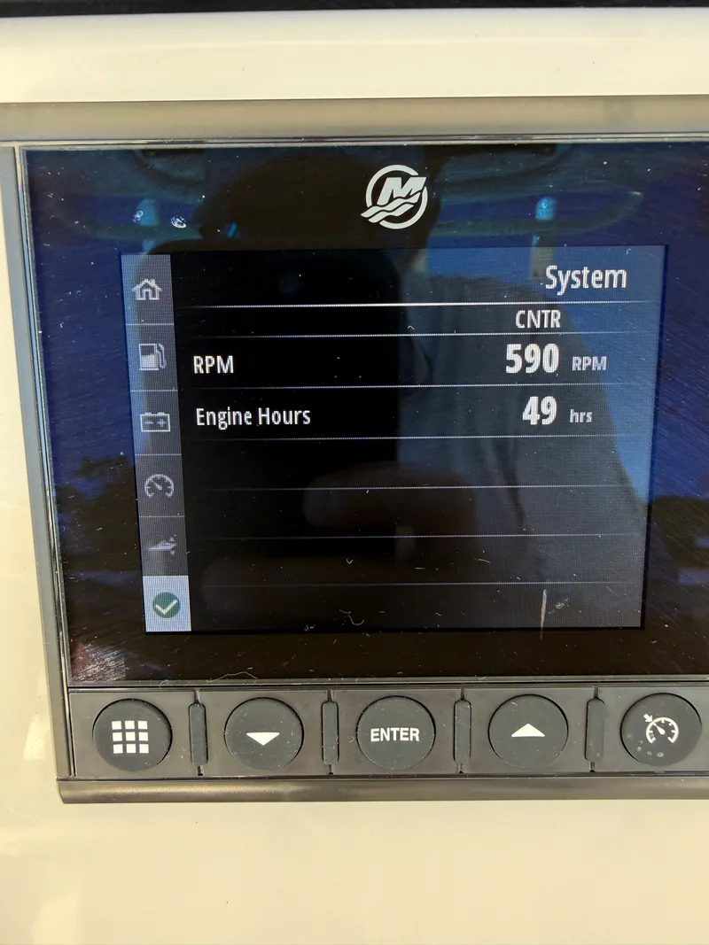 Slide: The Image of 2024 Boston Whaler 230 Outrage system display showing 590 RPM and 49 engine hours. - 36
