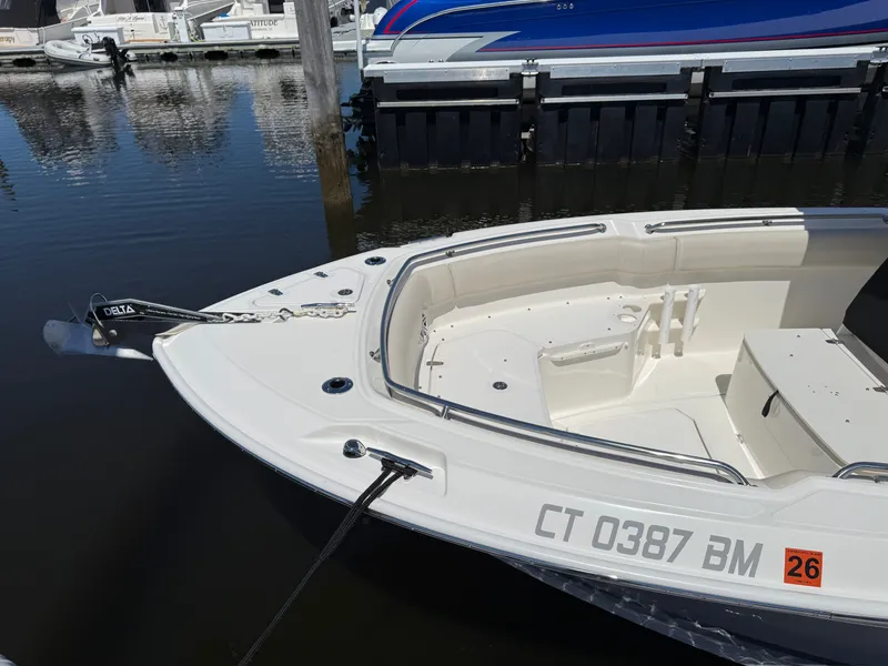 Slide: The Image of Boston Whaler 230 Outrage 2024 at dock, front view. - 8
