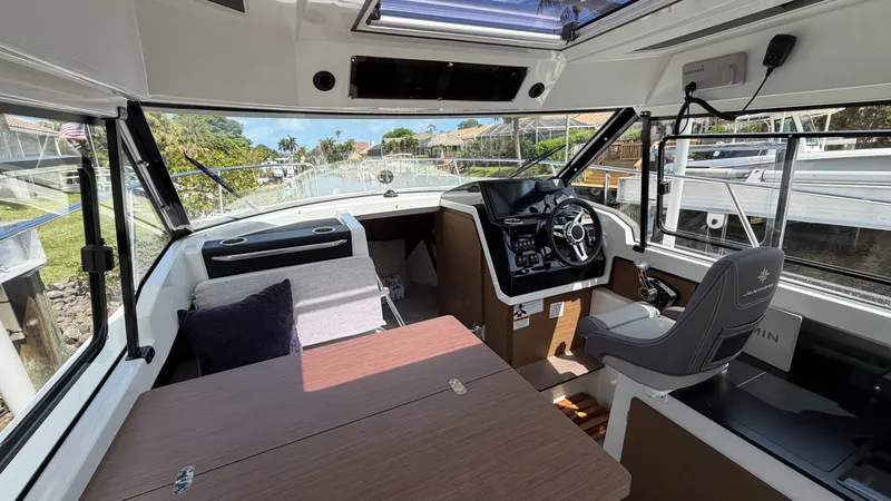 Slide: The Image of Interior of 2024 Jeanneau NC 795 Series 2 with helm and seating area. - 27