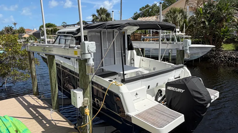 Slide: The Image of 2024 Jeanneau NC 795 Series 2 boat docked with Mercury engine. - 3