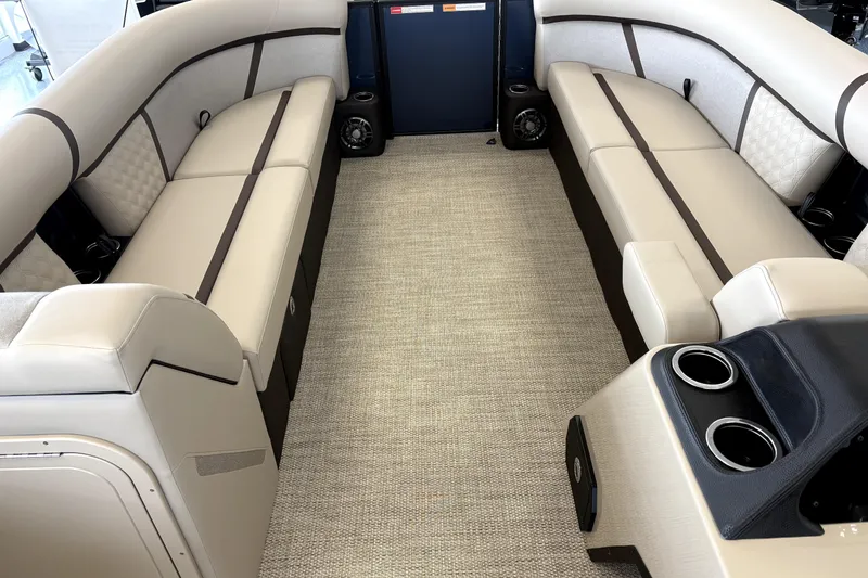 Slide: The Image of Crest 235 SLC Conquest 2026 pontoon boat in showroom. - 2