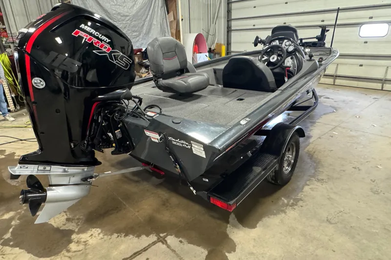Slide: The Image of 2022 Tracker Pro Team 190 TX boat with Mercury Pro XS engine in a garage. - 3