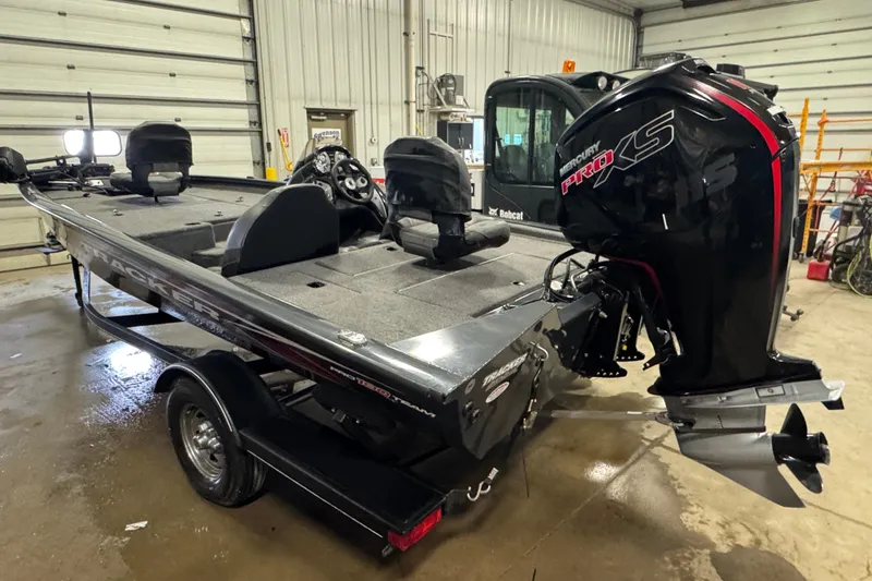 Slide: The Image of 2022 Tracker Pro Team 190 TX boat with Mercury Pro XS engine in a garage. - 4