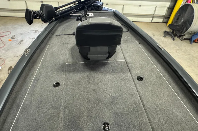 Slide: The Image of 2022 Tracker Pro Team 190 TX boat interior with gray carpet and seating. - 6