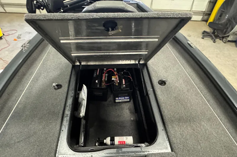 Slide: The Image of Open storage compartment of 2022 Tracker Pro Team 190 TX boat showing battery and equipment. - 9