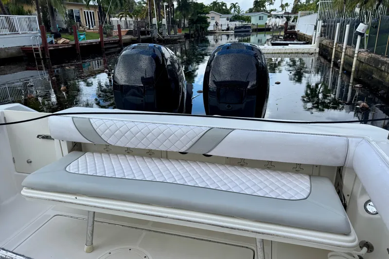 Slide: The Image of 2006 Boston Whaler 320 Outrage Cuddy Cabin bathroom with toilet and storage compartments. - 13