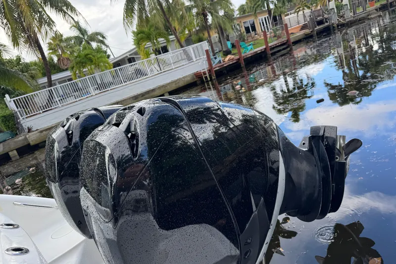 Slide: The Image of 2006 Boston Whaler 320 Outrage Cuddy Cabin boat interior with rod holders and seating. - 16