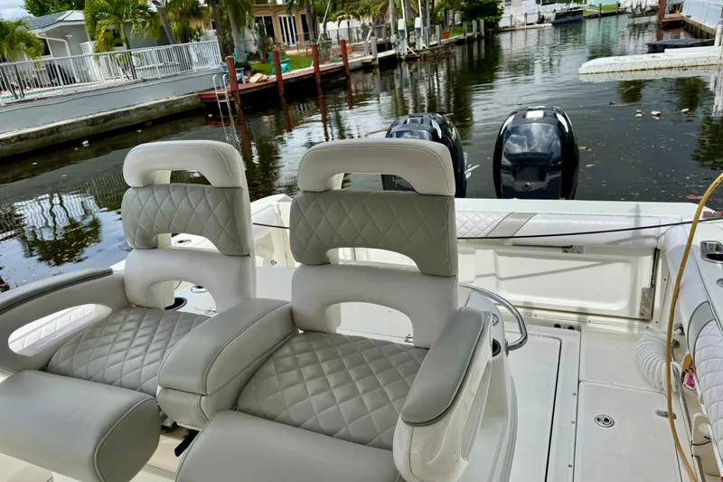 Slide: The Image of 2006 Boston Whaler 320 Outrage Cuddy Cabin docked near palm trees. - 19