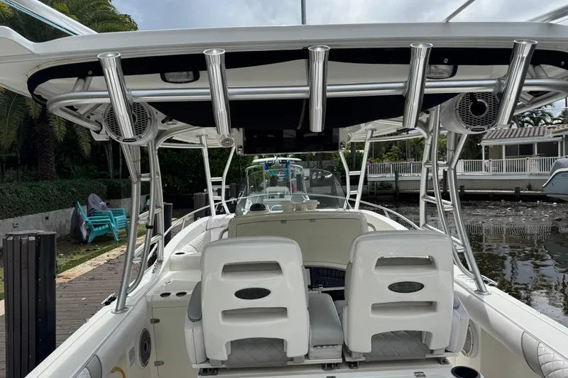 Slide: The Image of 2006 Boston Whaler 320 Outrage Cuddy Cabin docked near palm trees. - 20