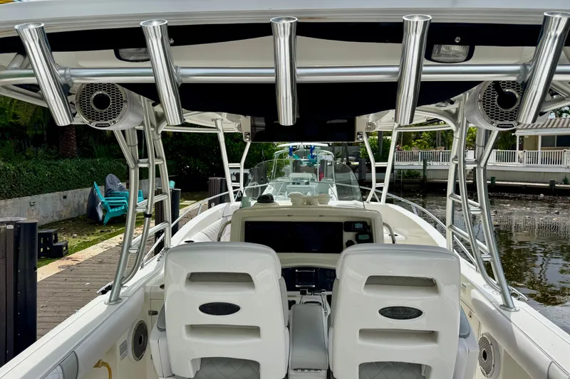 Slide: The Image of 2006 Boston Whaler 320 Outrage Cuddy Cabin interior with seating and storage compartments. - 22