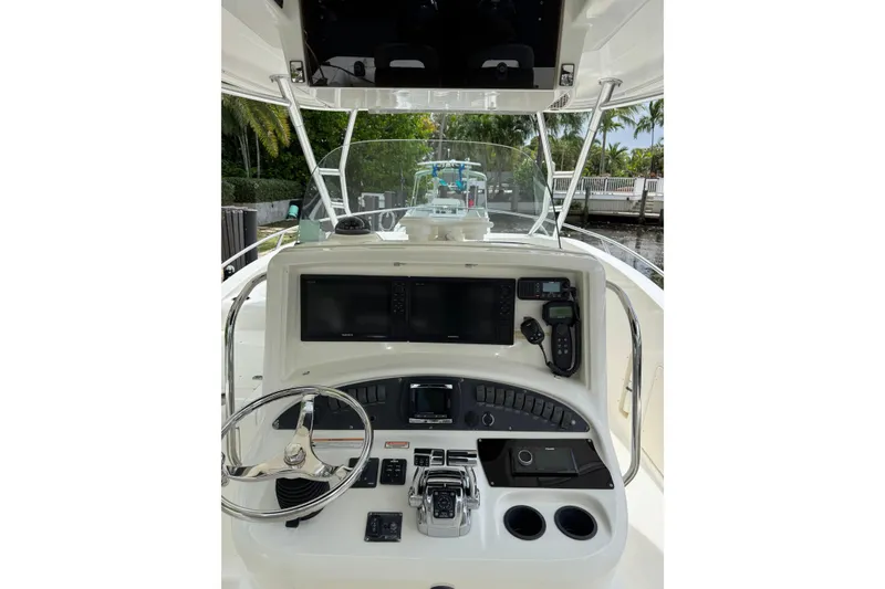 Slide: The Image of Outboard motor of a 2006 Boston Whaler 320 Outrage Cuddy Cabin near a dock. - 25