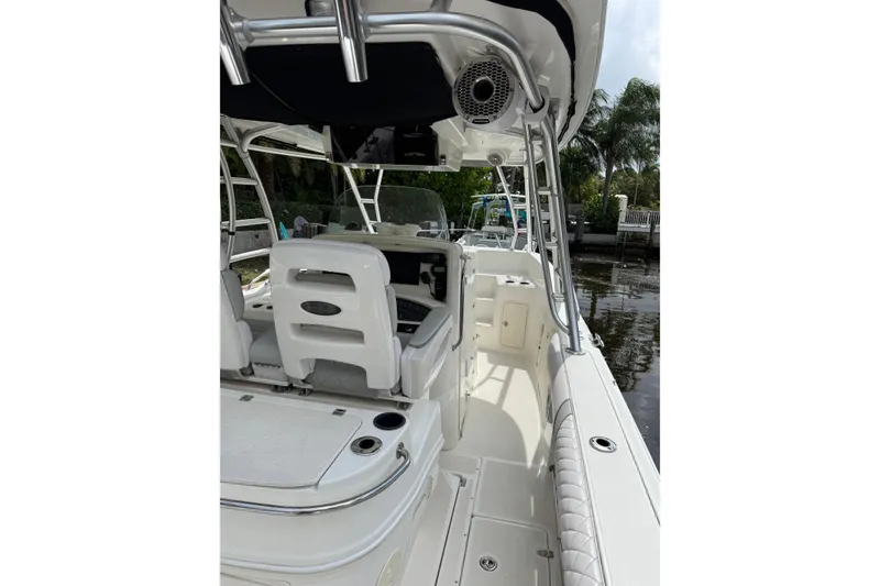 Slide: The Image of Twin outboard motors on a 2006 Boston Whaler 320 Outrage Cuddy Cabin by a canal. - 26