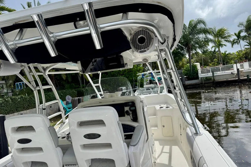 Slide: The Image of Twin outboard motors on a 2006 Boston Whaler 320 Outrage Cuddy Cabin by a canal. - 27