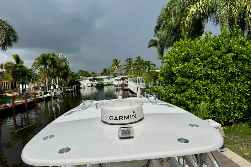 Slide: The Image of 2006 Boston Whaler 320 Outrage Cuddy Cabin docked under stormy skies. - 4