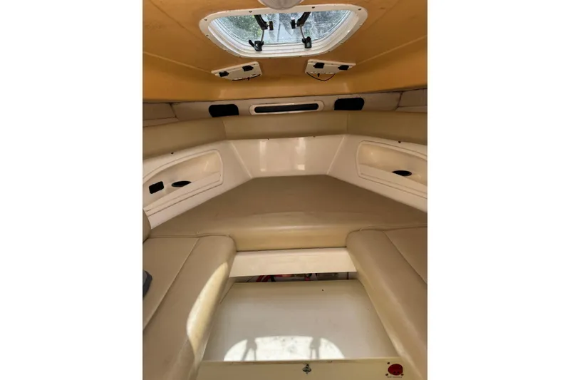 Slide: The Image of 2006 Boston Whaler 320 Outrage Cuddy Cabin with luxurious seating and dual outboard motors. - 9