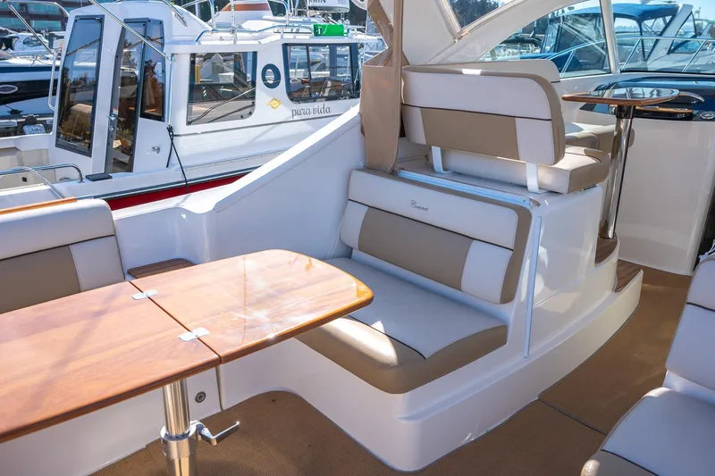 Slide: The Image of Luxurious seating area on a 2014 Tiara Yachts 3100 Coronet, docked at a marina. - 14