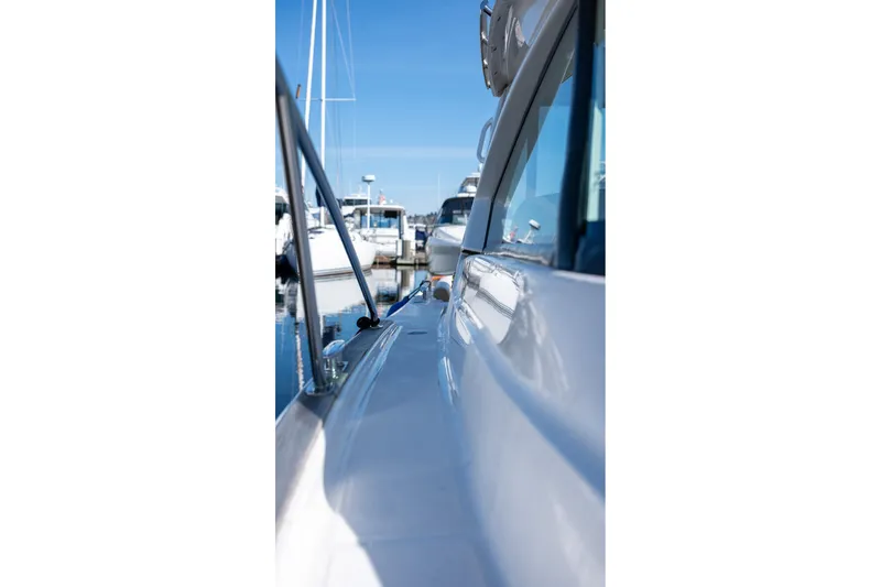 Slide: The Image of 2014 Tiara Yachts 3100 Coronet docked in a marina, surrounded by other boats. - 20